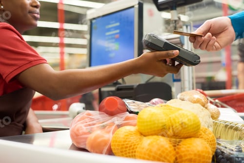 Preview: Young black woman holding payment terminal while buyer holding credit card