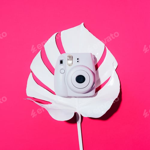 Preview: Vilnius, Lithuania - September 16, 2019: FUJIFILM INSTAX Mini Instant Film Camera on pink background
