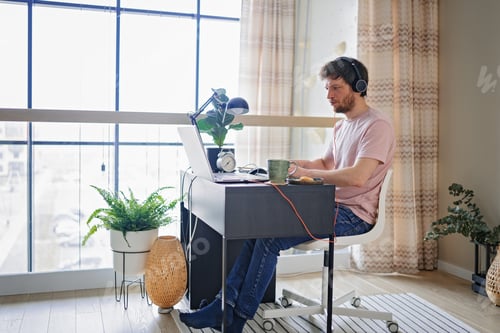 Preview: Adult male developer at online meeting of coworkers. Webcam conference on laptop