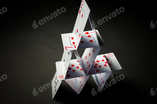 Preview: house of playing cards over black background