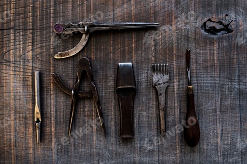 Preview: High angle close up of selection of saddle making hand tools.
