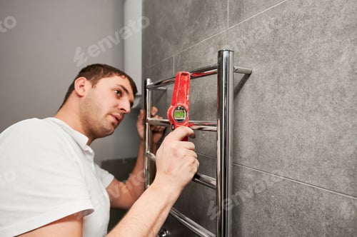 Preview: Plumber Installs New Heated Towel Rail in Bathroom