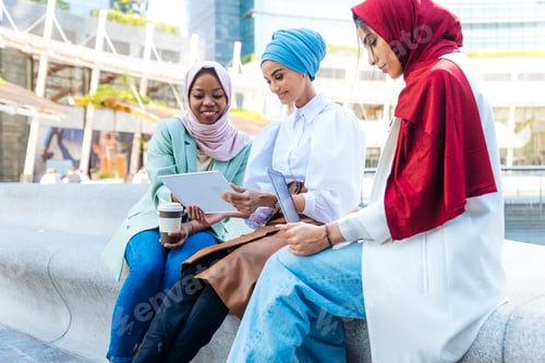 Preview: Beautiful muslim girl wearing hijab bonding outdoors