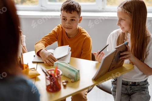 Preview: Children Studying Together at Desk in Classroom