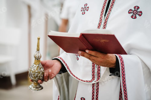 Preview: The priest holds a bible in the church. Holy sacramental event. Close up.