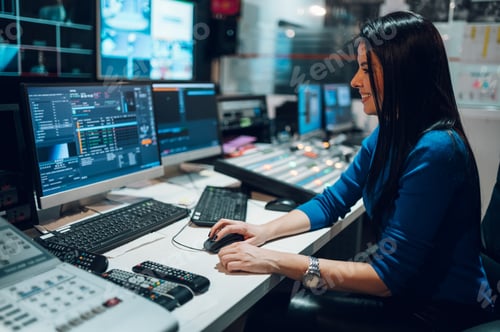 Preview: Middle aged woman using equipment in control room on a tv station