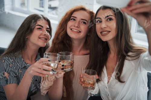 Preview: Three beautiful girls takes selfie with drinks in their hands