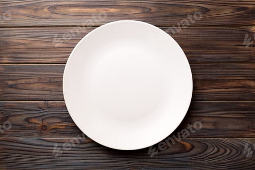 Preview: Top view of empty light plate on wooden background. Empty space for your design