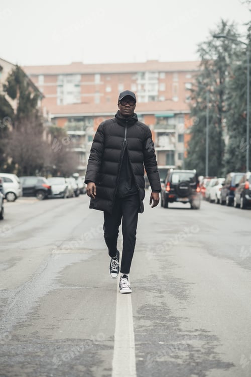 Preview: young black man running in the street and looking camera