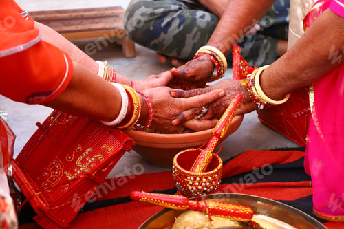 Preview: Closeup of two people doing an Indian traditional ritual