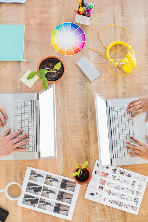 Preview: Casual business partners working on laptop in the office