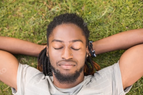 Preview: Handsome hipster relaxing in the park on a sunny day