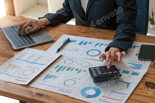 Preview: Close up businesswoman using calculator for do math finance on wooden desk in office and business