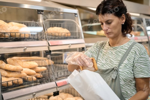 Preview: Supermarket employee placing bread in paper bag economic crisis and inflation