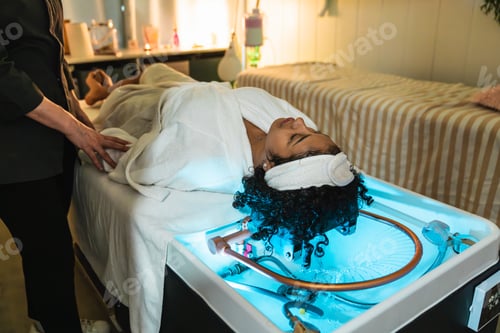 Preview: Beautician preparing client for innovative pressurized water hair treatment