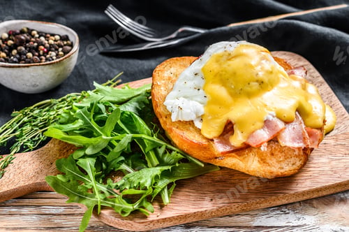 Preview: Brioche sandwich with bacon, egg Benedict and hollandaise sauce. White background. Top view