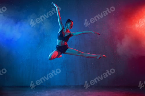 Preview: Slim ballerina jumping under rain