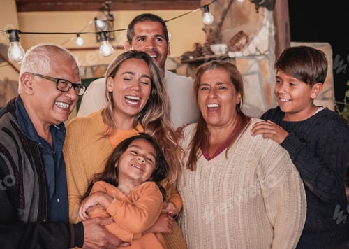 Preview: Hapy latin family smiling on camera - Family love