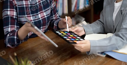 Preview: Two artists working on tablet, colour paper tone on workspace at the office