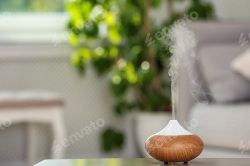 Preview: Aroma oil diffuser lamp on table against blurred background