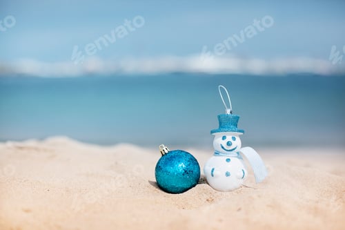 Preview: New Year's snowman in white in a blue hat on a background of a beautiful sea