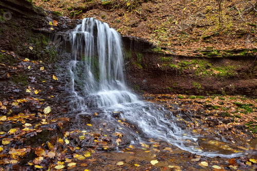 Preview: Beautiful landscape with a waterfall in the autumn forest