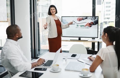 Preview: Shot of a pregnant young businesswoman delivering a presentation to her team in a modern office