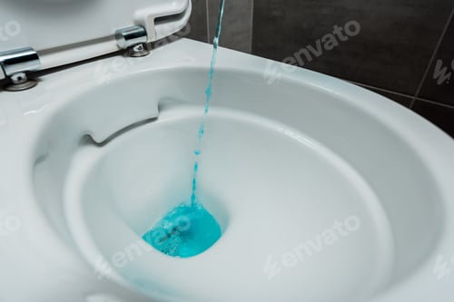 Preview: close up view of blue liquid detergent pouring into ceramic clean toilet bowl in modern restroom