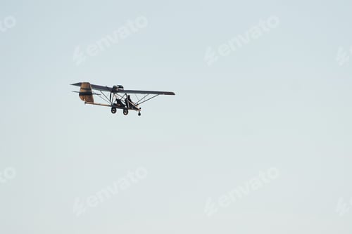 Preview: Plane flying high up in the cloudless sky at daytime. Male pilot