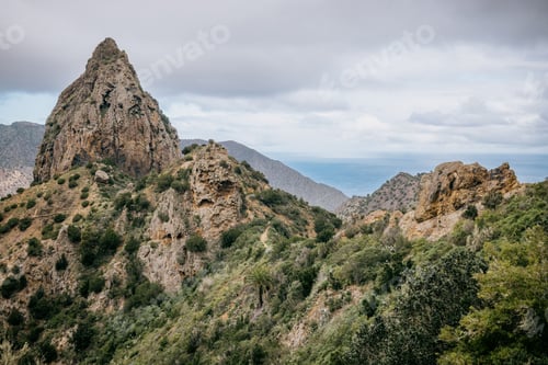 Preview: Scenic landscape featuring a mountains in the distance covered with trees and shrubs