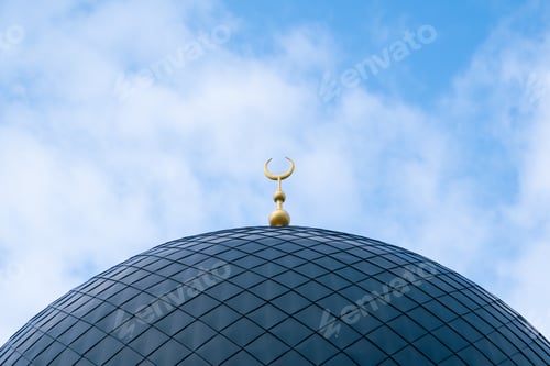Preview: Close-up shot of the gambiz dome with a crescent moon on top of a Muslim mosque against a blue sky