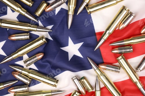 Preview: Many yellow 9mm and 5.56mm bullets and cartridges on United States flag