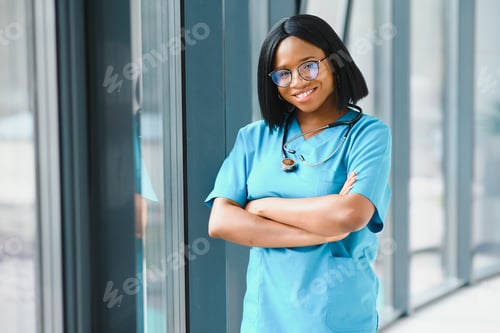 Preview: Portrait of African American woman doctor smiling in hospital.