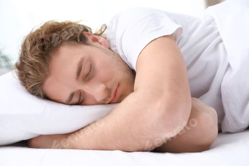 Preview: Handsome young man sleeping on pillow at home. Bedtime