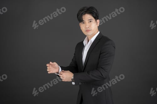 Preview: Business man wearing a black suit raising hands doing different gestures.