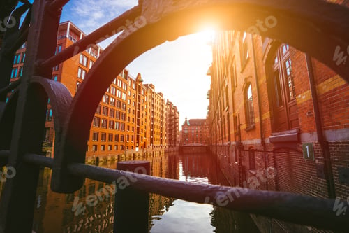 Preview: Speicherstadt Hamburg. Famous landmark of old buildings made with red bricks. Bridge and sun rays in