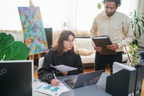Preview: Female worker and her indian coworker doing their work in sunny room