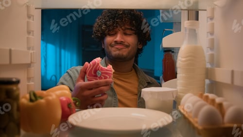 Preview: Point of view POV from inside refrigerator hungry Indian man Arabian guy male at night kitchen open