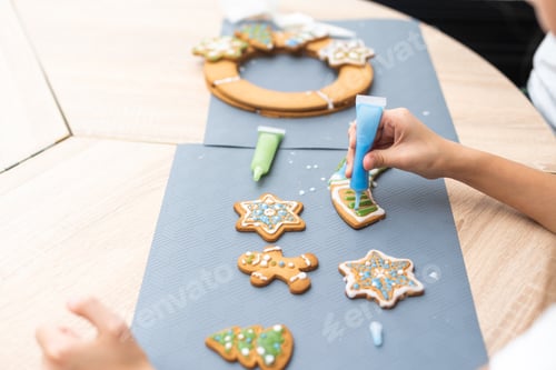 Preview: Children decorated Christmas gingerbread cookies on the table