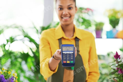 Preview: Smiling florist holding a POS terminal