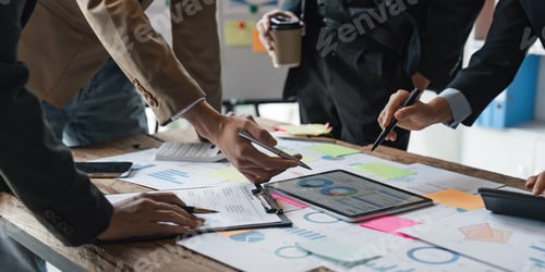 Preview: Business people meeting using laptop computer, calculator, stock market chart paper for analysis