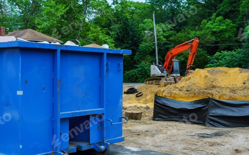 Preview: Blue metal waste container with building debris a building for recycling.