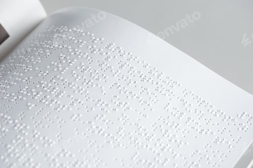 Preview: close up view of braille text on white paper isolated on grey