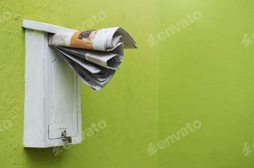 Preview: The latest paper delivered straight to your mailbox. Cropped shot of newspapers in a letter box.