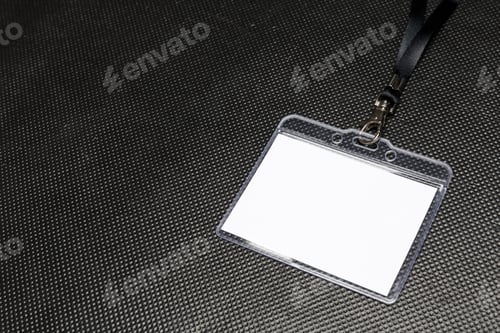 Preview: Blank name tag on a dark surface ready for use at an event or meeting