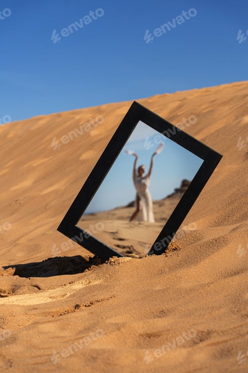 Preview: Mirror Frame in Desert Reflecting Woman in a Flowing Dress Holding Feathers
