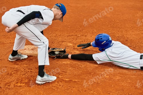 Preview: Two teenage boys compete energetically in a thrilling baseball game on the field