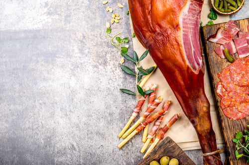Preview: Appetizers table with spanish iberian whole ham jamon serrano, snacks, olives and red and rose wine