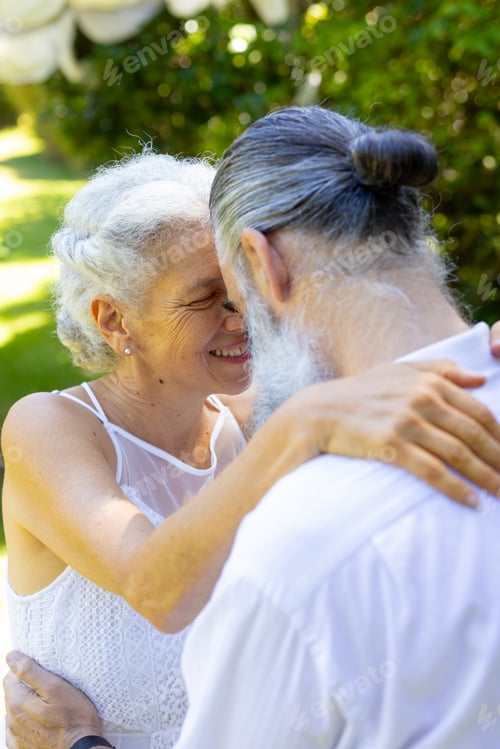 Preview: Wedding in garden, senior bride and groom embracing outdoors