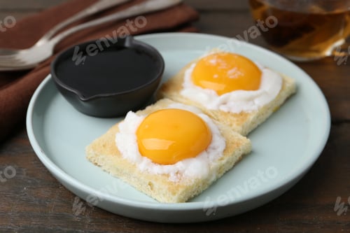 Preview: Tasty kaya toasts with half-boiled eggs served on wooden table, closeup. Traditional asian breakfast